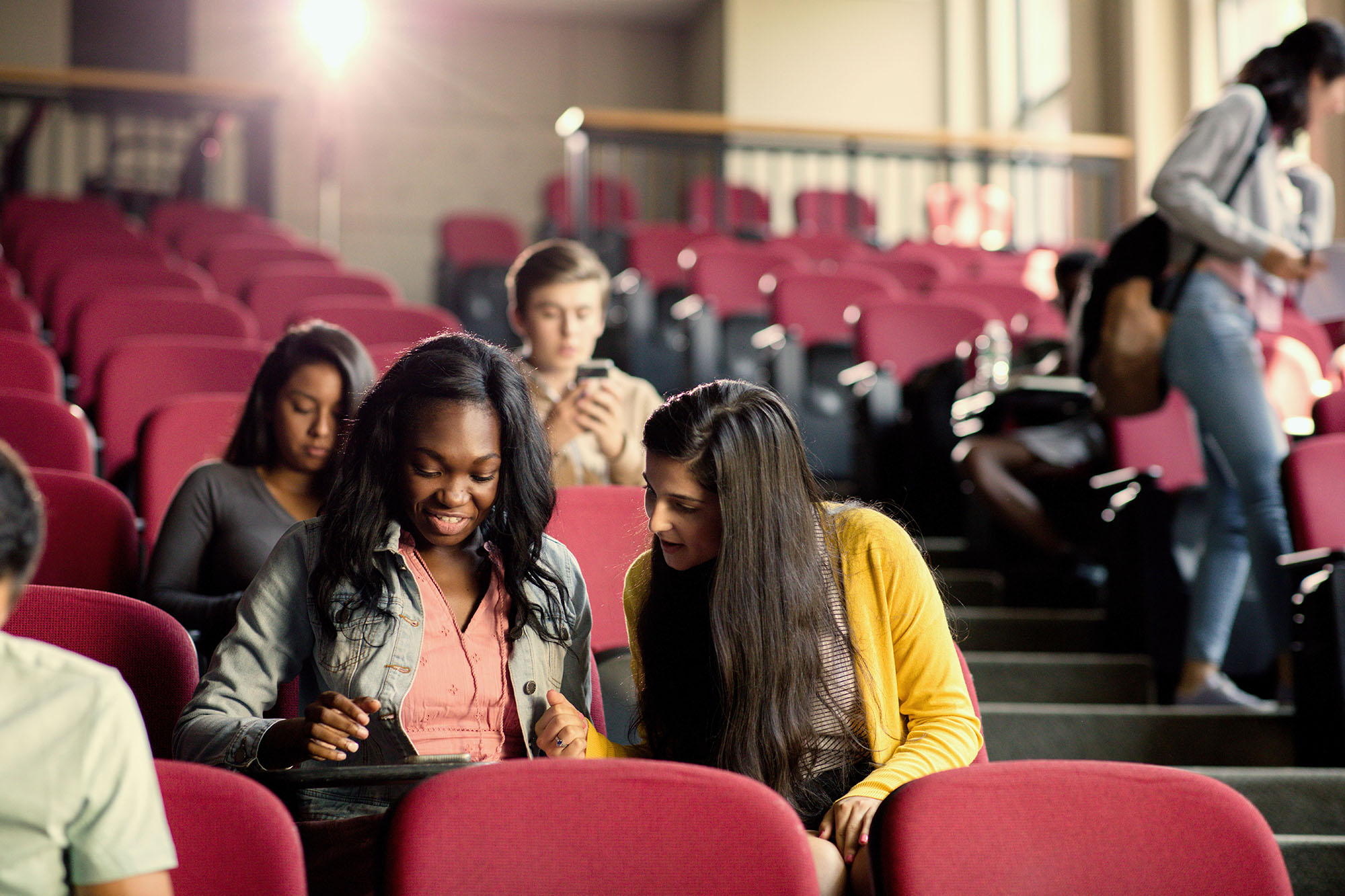 Two high school students having a conversation in a classroom at Harvard Summer School